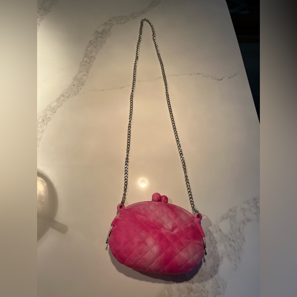 Fabulous pink silicone kids purse with silver tone chain.